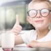 young boy giving a thumbs up while having a beverage from a 13oz lavender hue Italian beverage glass.