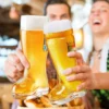 Friends cheers with beer boots at a celebration.