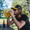 Man trying to chug a beer boot in a single go, good luck!