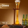 half yard glass on stand next to beer bottles.