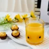 daisy double old fashioned glass full of orange juice in setting with chocolates.