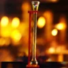 full yard of ale on a wooden stand with a soft backlit background.